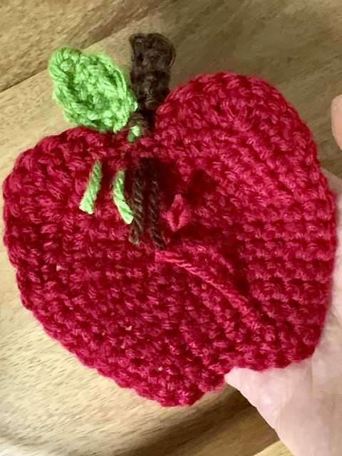 apple base in red yarn with stem and leaf attached