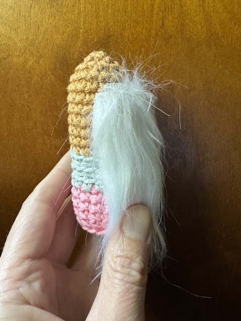 Demonstration of where to position the crochet pencil gnome beard on the base
