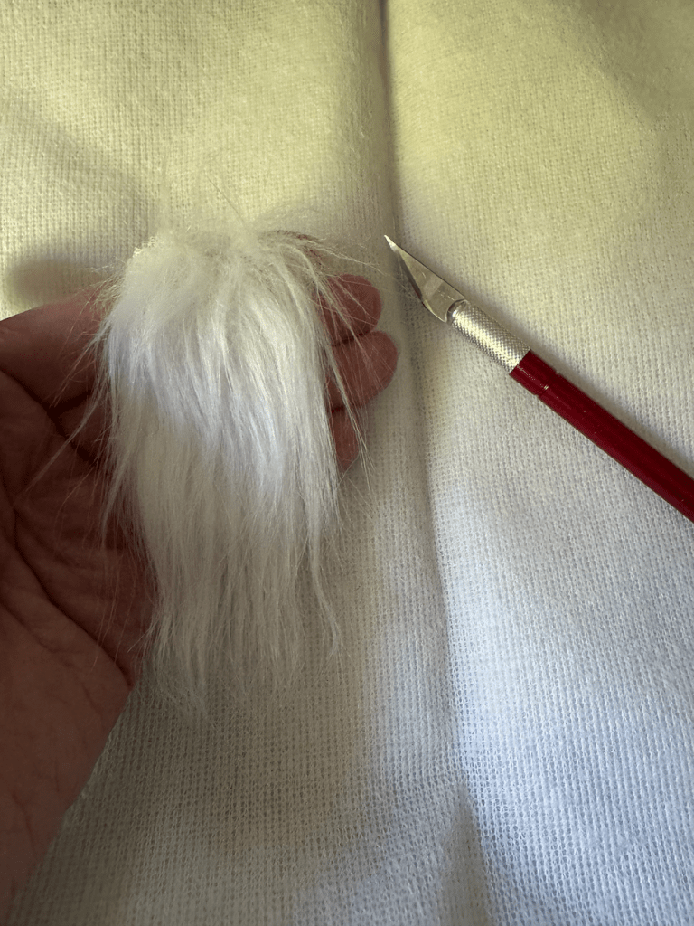 Faux fur beard for pencil gnome with a craft knife example